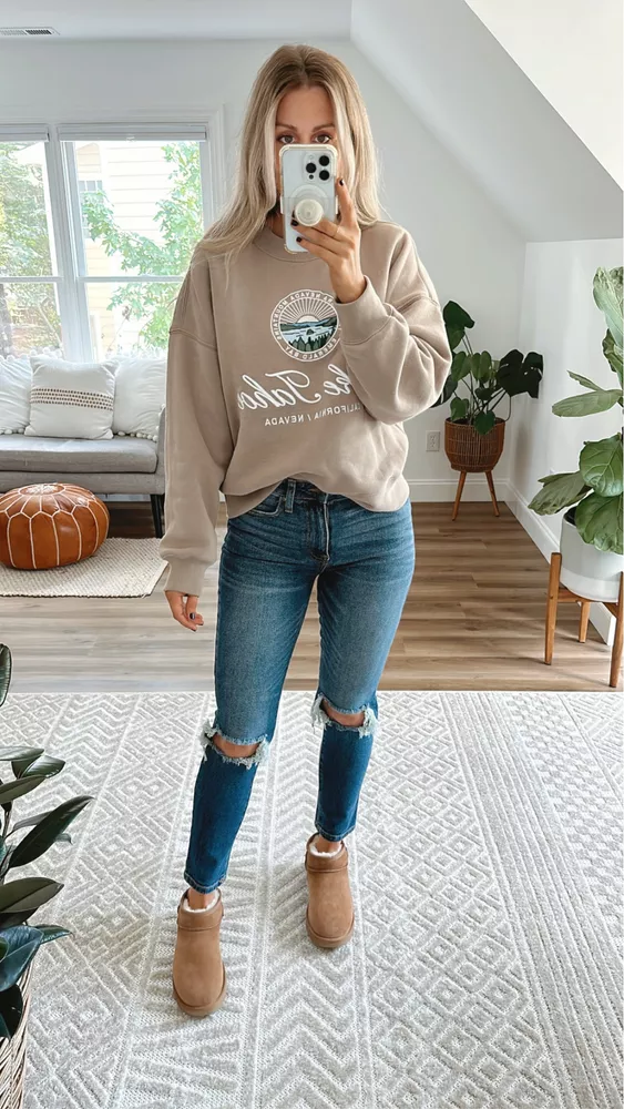 torn denim jeans with a sweater and uggs boots