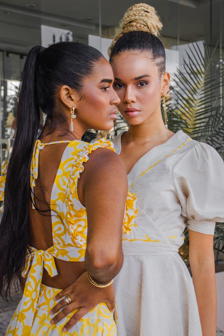 Two women posing in summer outfits, showcasing contemporary fashion and elegance.